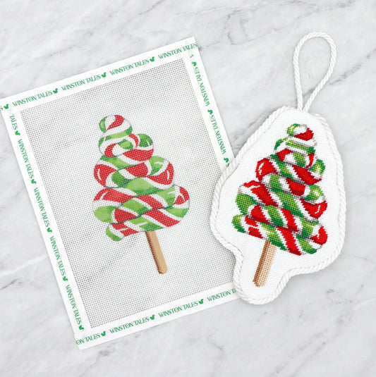 Needlepoint canvas of Decorative ornament with candy cane design on a white marble surface